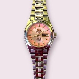 Orient rose gold & stainless steel water resistant womens watch.